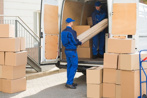 Professional movers handling furniture during a home move in Egham